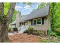 Home exterior featuring a chimney, a white wooden porch and stairs, and neutral colored siding at 11102 Sundown Ln, Charlotte, NC 28226