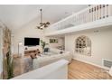 Bright living room with vaulted ceiling, hardwood floors, comfortable sofa, and a stone fireplace at 11102 Sundown Ln, Charlotte, NC 28226