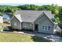 Charming single-story home featuring a well-maintained lawn and classic architectural details at 126 Strand Rd, New London, NC 28127