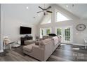 Spacious living room featuring vaulted ceilings, modern lighting, and access to the backyard at 126 Strand Rd, New London, NC 28127