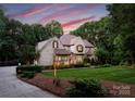 Beautiful exterior view of the home showing the well-maintained lawn and lush surrounding trees at 12835 Ninebark Trl, Charlotte, NC 28278