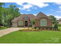 Charming brick home features a well-manicured lawn and mature landscaping in a desirable community at 1400 Delaney Dr, Matthews, NC 28104