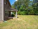 Back yard and covered patio perfect for outdoor relaxation at 14506 Knowledge Cir, Charlotte, NC 28277
