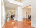 Bright foyer with hardwood floors, a staircase, and views of the living and dining areas at 15037 Taylor Ridge Ln # 25, Charlotte, NC 28273