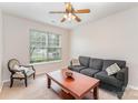 Cozy room featuring a comfortable gray sofa, armchair, coffee table, and a large window at 15037 Taylor Ridge Ln # 25, Charlotte, NC 28273