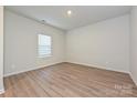 Bright bedroom with natural light, neutral walls, and wood-look flooring at 1505 Harper Landing Blvd, Stanley, NC 28164