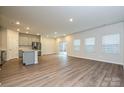Spacious open-concept living area featuring hardwood floors, recessed lighting, and sliding door access to outdoors at 1505 Harper Landing Blvd, Stanley, NC 28164