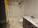 Well-lit bathroom with a shower-tub combo, modern vanity, and decorative marble countertop at 1700 Old Towne Ct, Charlotte, NC 28217