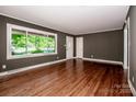Bright living room with beautiful hardwood floors, a large window, and neutral wall color at 175 Triplett Rd, Cleveland, NC 27013