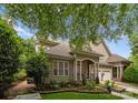 Charming home featuring a well-manicured lawn, mature trees, and a two-car garage at 18846 Cloverstone Cir, Cornelius, NC 28031