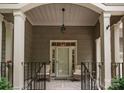 Cozy front porch with seating and a decorative light fixture at 18846 Cloverstone Cir, Cornelius, NC 28031