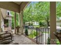 Inviting front porch with comfortable seating and a view of the landscaped front yard at 18846 Cloverstone Cir, Cornelius, NC 28031