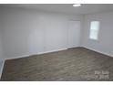 Bedroom with light walls, wood flooring and a double door closet at 1900 Walkup Ave # 1, Monroe, NC 28110