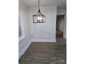 Dining area features modern light fixture, neutral walls, and updated flooring at 1900 Walkup Ave # 1, Monroe, NC 28110