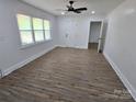 Open-plan living room with natural light, ceiling fan and wood flooring at 1900 Walkup Ave # 1, Monroe, NC 28110