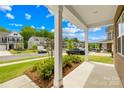 Inviting front porch view showcasing the neighborhood, mature landscaping, and a glimpse of the home's curb appeal at 191 Tackle Box Dr, Troutman, NC 28166