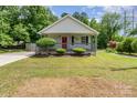 Charming single-Gathering home featuring a welcoming front porch and beautiful landscaping at 201 Easy St, Concord, NC 28027