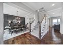Hallway featuring hardwood floors, stairs, and an entryway to the dining room and living room at 2025 Masons Bend Dr, Fort Mill, SC 29708