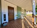 Spacious front porch with a seating area and a view of the yard, featuring a rocking chair and welcome mat at 222 Brevard St, Statesville, NC 28677
