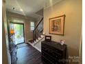 Lovely entryway featuring hardwood floors, stairs, and ample natural light from front door at 2279 Eversham Nw Dr, Concord, NC 28027
