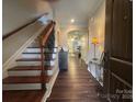 Inviting entryway with hardwood floors, staircase, and view into the home at 2279 Eversham Nw Dr, Concord, NC 28027