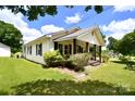 Quaint single-story home with a cozy front porch and flourishing garden beds at 2306 W C St, Kannapolis, NC 28081