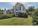 Charming two-story home featuring a well maintained lawn and manicured hedges at 321 W Bank St, Salisbury, NC 28144