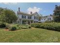 Charming two-story home featuring a well maintained lawn and manicured hedges at 321 W Bank St, Salisbury, NC 28144