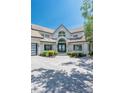 Front exterior view of a home with a prominent arched entryway and a paved driveway at 3386 Governors Island Dr, Denver, NC 28037
