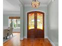 Inviting foyer showcasing a decorative stained glass front door at 3815 Stoney Ridge Trl, Charlotte, NC 28210