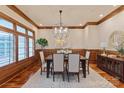 Formal dining room with wood trim, hardwood floors, and a decorative chandelier at 405 Gladelynn Way, Waxhaw, NC 28173