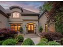 Inviting front entrance with a stone archway and beautifully landscaped garden at 405 Gladelynn Way, Waxhaw, NC 28173