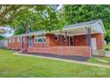 Beautiful brick home with a covered porch and manicured lawn, offering a welcoming curb appeal at 413 N Mulberry St, Cherryville, NC 28021
