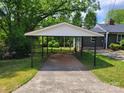 Carport with a concrete floor and a view of the fenced-in backyard at 423 S Rhyne St, Dallas, NC 28034