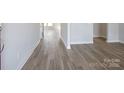 Hallway featuring neutral paint, light-colored plank flooring, and bright, natural light at 426 Bent Burr Crk, York, SC 29745