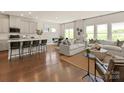 Bright, open-concept living room featuring hardwood floors and eat-in kitchen with modern finishes at 426 Bent Burr Crk, York, SC 29745