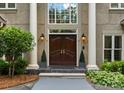 Close-up of the double front doors flanked by columns and manicured greenery at 4429 Cameron Oaks Dr, Charlotte, NC 28211