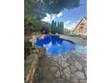 Inviting backyard pool with stone surround and decorative flamingo, a peaceful oasis at 504 Johnsfield Rd, Shelby, NC 28150