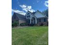 Beautiful two-story brick home with a well-manicured lawn and traditional architectural details at 504 Johnsfield Rd, Shelby, NC 28150