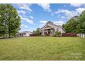 A beautiful single-Gathering home with a lush lawn and complemented by a well-maintained fenced yard at 5252 Ramblewoods Ave, Claremont, NC 28610