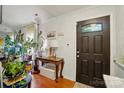 Inviting entryway featuring hardwood floors, elegant console table, and decorative door at 6221 Thermal Rd, Charlotte, NC 28211
