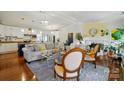 Open-concept living room with neutral furniture, hardwood floors, and stylish lighting at 6221 Thermal Rd, Charlotte, NC 28211
