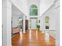 Grand foyer showcasing hardwood floors, soaring ceilings, and abundant natural light at 7006 Olde Sycamore Dr, Mint Hill, NC 28227