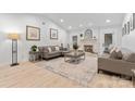 Spacious living room featuring modern furnishings, a decorative fireplace, and abundant natural light at 7416 Cross Tie Ct, Mint Hill, NC 28227