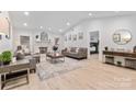 Bright living room with a fireplace, vaulted ceilings, recessed lights and hardwood floors at 7416 Cross Tie Ct, Mint Hill, NC 28227