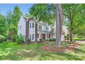 Picturesque two-story home with brick accents, bay window, and a welcoming front porch at 7600 Ridgefield Dr, Charlotte, NC 28269