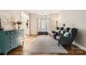 Inviting living room featuring hardwood floors, large windows, and comfortable seating at 7600 Ridgefield Dr, Charlotte, NC 28269