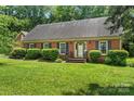 Inviting brick home featuring well-maintained landscaping and a welcoming front entrance at 8017 Prince George Rd, Charlotte, NC 28210