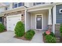 Inviting front entrance features stone accents, fresh landscaping, and a secure CPI security system at 8018 Saluda Dr, Charlotte, NC 28269