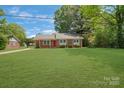 Charming single-story home featuring a well-maintained lawn and beautiful landscaping at 8206 Idlewild Rd # 22, Indian Trail, NC 28079